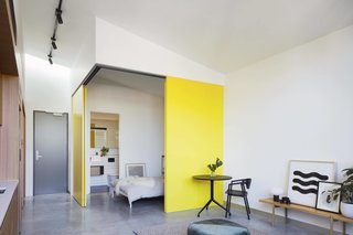 Australian practice MUSK Architecture Studio maximized the units of Coppin Street Apartment with flexible floor plans and large sliding doors that expose of reveal some of the bedrooms.