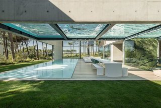 The Wall House in Cascais, a coastal town in an area known as the Portuguese Riviera, is an 11,840-square-foot home made with concrete, wood, and glass—and boasts a pair of large swimming pools on two levels. Designed by José Guedes Cruz, César Marques, and Marco Marinho of the Portugal-based firm Guedes Cruz Architects, The Wall House is laid out in an open-box plan, and is fitted with plenty of glass windows to enhance the synergy between its interior and exterior spaces.