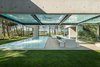 Modern home with Outdoor, Back Yard, Trees, Grass, Large Pools, Tubs, Shower, Large Patio, Porch, Deck, Wood Patio, Porch, Deck, Swimming Pools, Tubs, Shower, and Plunge Pools, Tubs, Shower. Designed by José Guedes Cruz, César Marques, and Marco Marinho of the Portugal-based firm Guedes Cruz Architects, The Wall House is laid out in an open-box plan, and is fitted with plenty of glass windows to enhance the synergy between its interior and exterior spaces. Photo of The Wall House