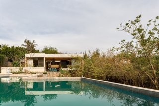 The Mexico City-based architects at Ambrosi | Etchegaray installed a 150,000-liter water tank that holds rainwater in this eco-friendly vacation home in Tepoztlán, Morelos. Solar energy warms the water in the tank when heating is required for the pool and shower water.