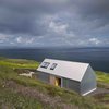Modern home with Exterior, House Building Type, Metal Roof Material, Metal Siding Material, Cabin Building Type, and Gable RoofLine. On the northwestern tip of Scotland’s Isle of Skye is a vacation rental that's inspired by the region’s traditional “crofter style” cottages, but covered with a skin of tin.
Designed and built by Gill Smith and Alan Dickson of Scottish practice Rural Design Architects, this house sits along the rugged Isle of Skye coast and has a rudimentary form that recalls children’s drawings of pitched-roof homes.
Smith and Dickson constructed the house using corrugated metal sheeting, which is commonly used for agricultural sheds or Photo of The Tinhouse