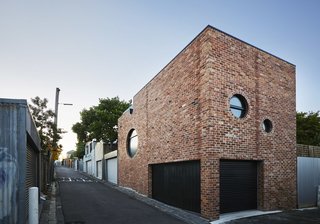 The solid brick facade is is broken up and certainly made more interesting by the incorporation of circular windows.