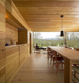 Try using the same finish on your kitchen cabinets, walls, and ceiling. This creates an effect that allows everything to blend in seamlessly with the rest of the home. Case in point: this home employs a consistent wood palette. 