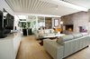 Modern home with Living Room, Sofa, Ceiling Lighting, Floor Lighting, Coffee Tables, Console Tables, Table Lighting, Wood Burning Fireplace, Standard Layout Fireplace, Media Cabinet, and Light Hardwood Floor. Nikolaus and Heather hired Urban Innovations, Inc. and MIM Construction Inc. to work on the renovation. When the project began, they discovered that the electrical and plumbing systems were also in bad condition. Photo 8 of Pierre Koenig's Scott House