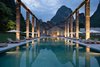 Modern home with Outdoor, Large Pools, Tubs, Shower, Landscape Lighting, Large Patio, Porch, Deck, Back Yard, Trees, and Grass. An old sugarcane dock was turned into a swimming pool, which offers views of the Karst mountains and Li River from a distance. Photo of Alila Yangshuo