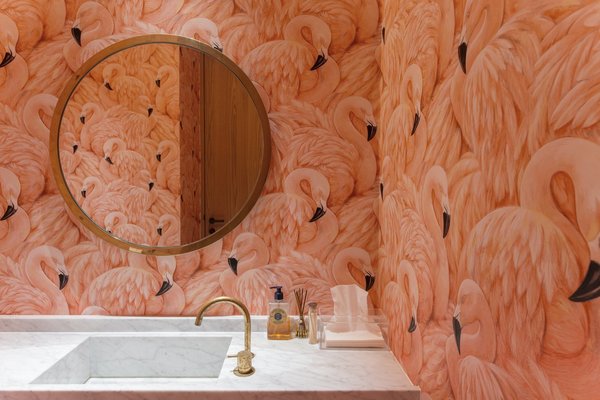 This Singapore apartment, renovated by Takenouchi Webb, features a guest bathroom covered in eye-popping flamingo-print wallpaper.