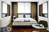 Modern home with Bedroom, Chair, Bed, Lamps, Table Lighting, Rug Floor, and Wall Lighting. Mirrors are used to visually enlarge some of the smaller rooms. Photo 9 of Roomers Munich