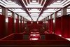 Modern home with Dining Room, Table, and Ceiling Lighting. The hotel’s private 1960s-inspired whisky bar named the Hidden Room would fit nicely into an Austin Powers movie. Behind a secret door along the back of the public bar, one can enter a space that’s almost entirely red with red wall panels, scarlet floors, banquettes, and tables. Photo 11 of Roomers Munich