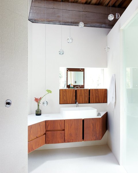 If you have a bathroom with tight corners, follow Omer Arbel Office Inc.'s lead and make good use of tricky nooks to showcase beautiful joinery, like they did for this angular home in a Canadian hayfield.