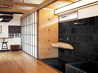 When redesigning “Madmen” actor Vincent Kartheiser’s Hollywood cabin, architect Funn Roberts installed custom shoji-style screens of to conceal the closet and provide privacy for the adjacent shower and soaking tub.