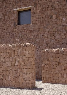 Red stone walls, reminiscent of structures from medieval times, are used in the construction of this villa in Ourika Valley. 