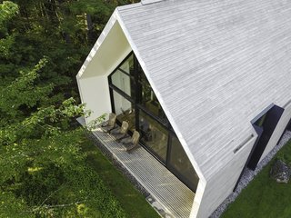 A slender wooden decked porch that looks out to the lake.