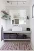 Modern home with Track Lighting and Rug Floor. Built-in shelves and an unframed mirror give the bathroom vanity a clean and streamlined look. Photo 12 of Hellum House
