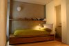 Modern home with Bedroom, Storage, Bed, Shelves, Wall Lighting, and Medium Hardwood Floor. The children's bedroom with a pullout storage area. Photo 15 of Girona Townhouse