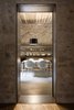 Modern home with Shelves, Floor Lighting, and Concrete Floor. A narrow threshold evokes the warren-like feel of the original interiors. Photo 13 of Girona Townhouse