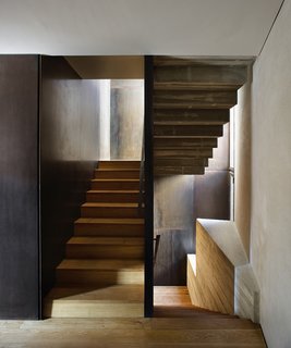 A staircase leads from the ground-level apartment up to the duplex.