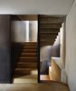 Modern home with Staircase, Wood Tread, and Metal Railing. The staircase that leads from the ground-level apartment to the duplex. Photo 6 of Girona Townhouse