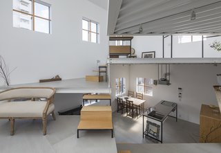 The living area at the heart of the house ascends up to the bedroom and bathroom.