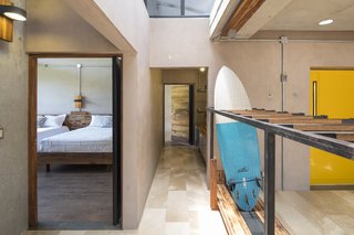 A bedroom with two beds is located in one of the buildings.