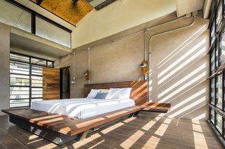 Glass walls are fitted on two sides of the master bedroom.