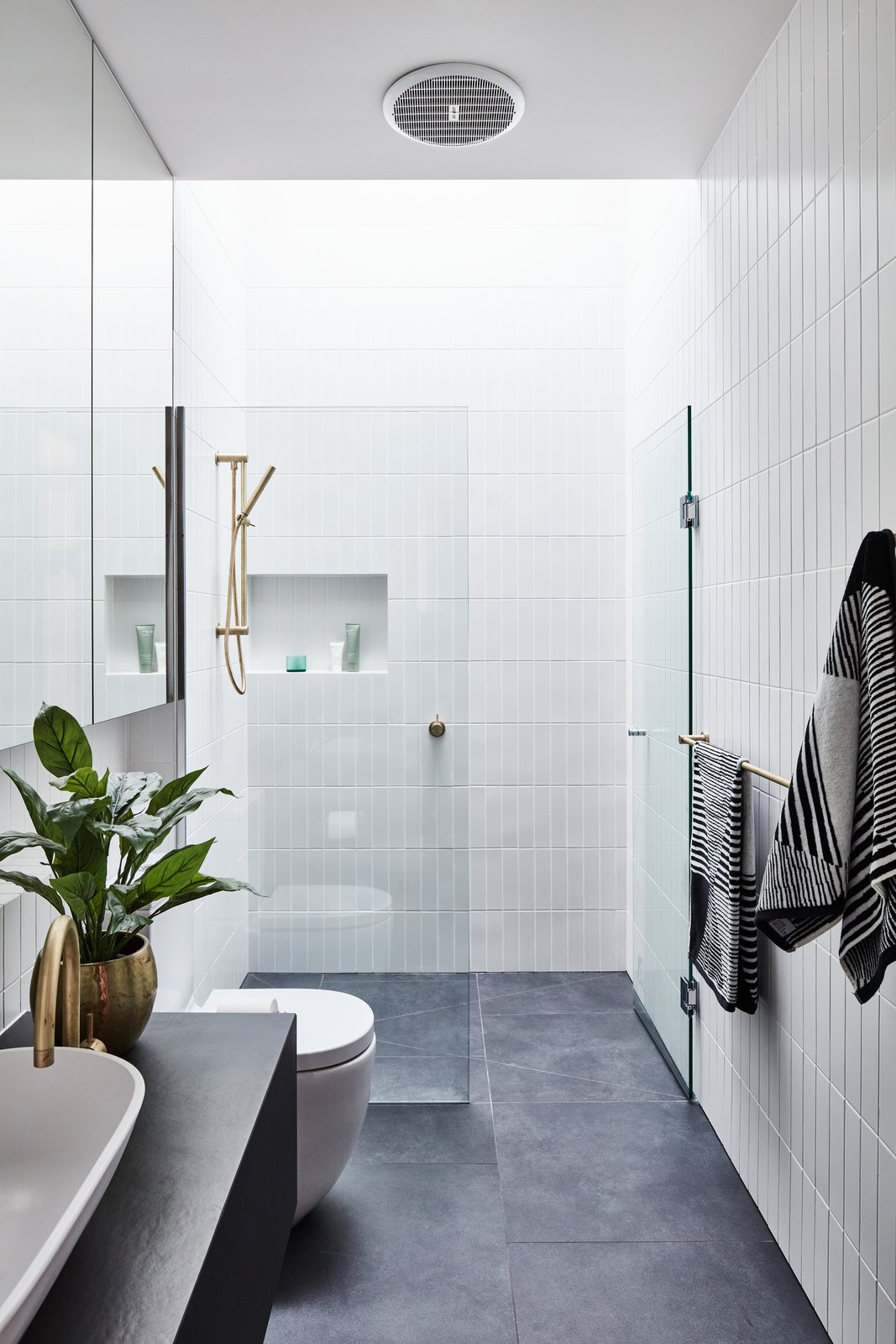 The bathroom is fitted with a clean and modern shower.