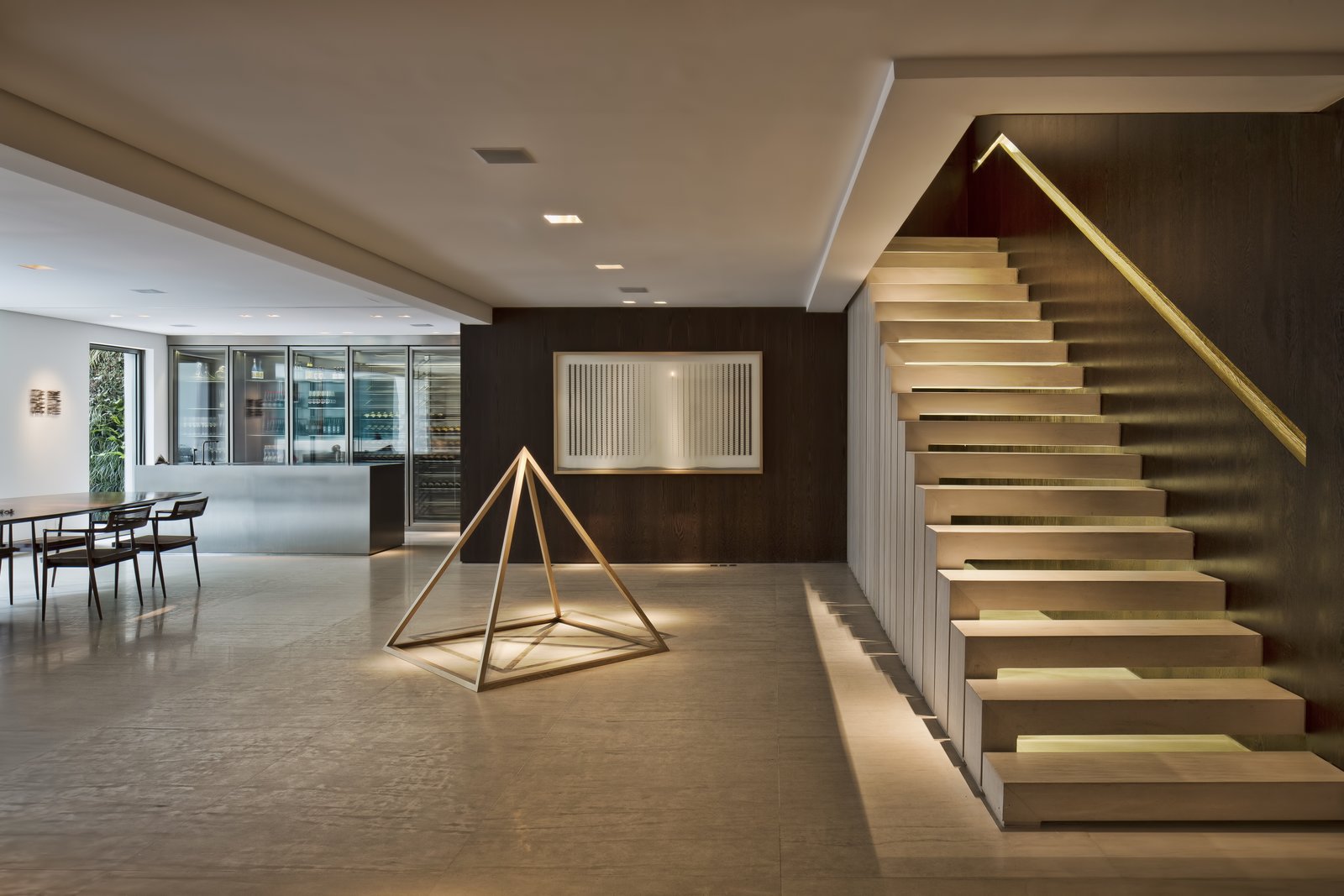 The living room, dining area, and kitchen are located on the lower level.