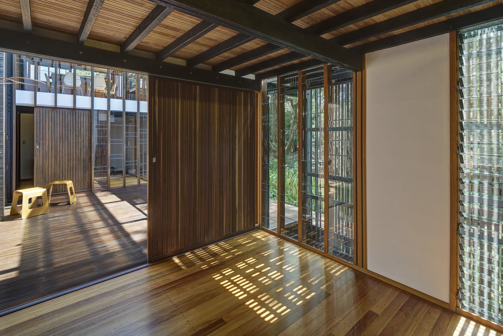 The indoor-outdoor feel of the house is intensified by the three primary views – of the river, towards the forested entry path, and to the sky – that can be enjoyed from within.