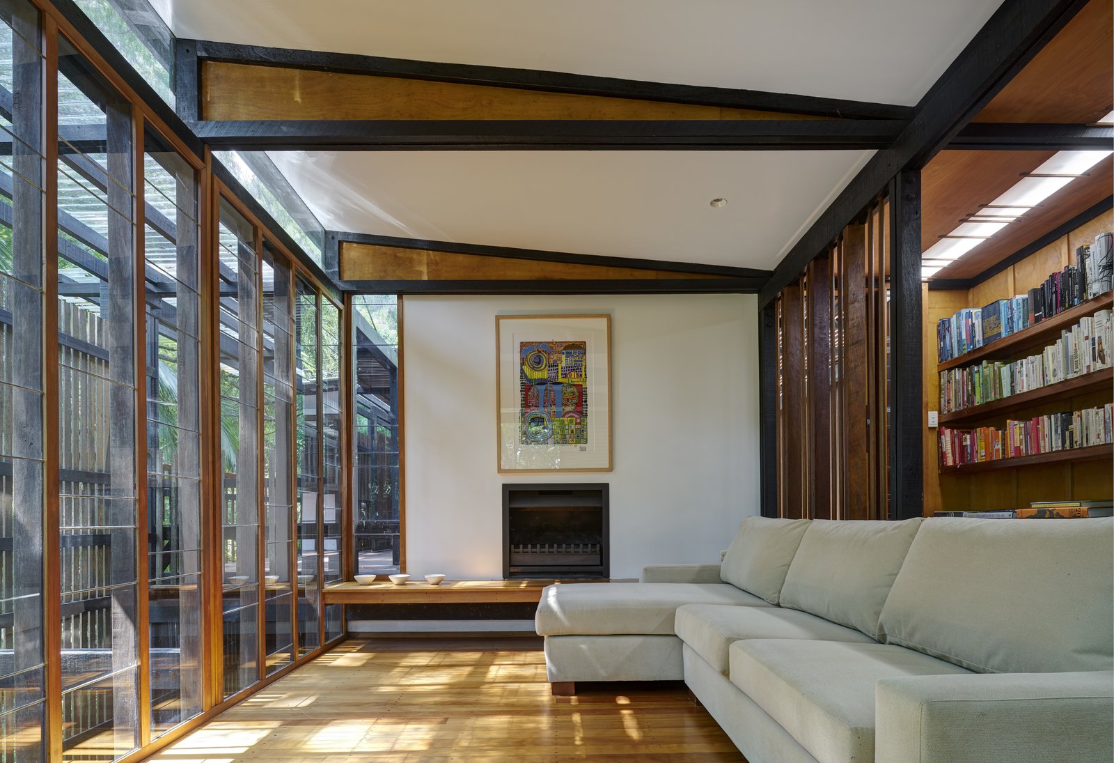 On the southern side of the house is library and living room with a fireplace.