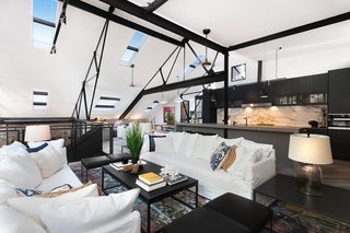 The living area on the upper level leads out to a rooftop terrace.
