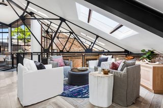 The soaring ceilings are interlaced with timber trusses and exposed steel.