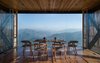Modern home with Dining Room, Chair, Medium Hardwood Floor, Table, and Recessed Lighting. The upper volume of the main building holds the dining facilities. Photo 5 of The Kumaon