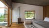 Modern home with Bedroom, Bed, Medium Hardwood Floor, and Bunks. In the chalet room, the bed, table, and seating were designed as a island unit finished in smooth cement render. Photo 8 of The Kumaon
