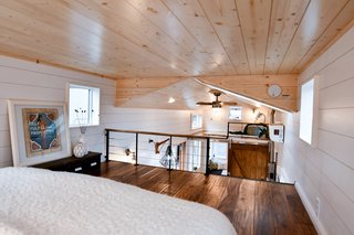 This couple took advantage of the gabled roof in their tiny home and opted to have their sleeping area in a lofted space.