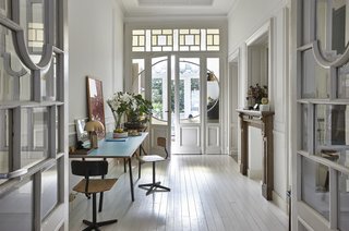Before the revamp, the original floors were painted gray. This gave the interiors a dark and tired look, so Taeymans opted for bright white instead.