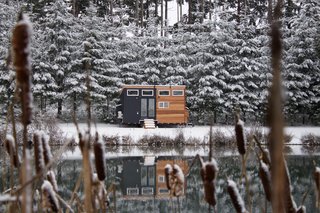 This house has an exterior of black panels and clear-grain cedar tongue-and-groove siding, and a rooftop deck that lets its owners enjoy the outdoors.