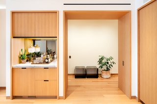 The kitchen includes a bar area with a wine cooler, two refrigerators, a fumed mirror backsplash, multiple pantries, and numerous modern appliances. 

