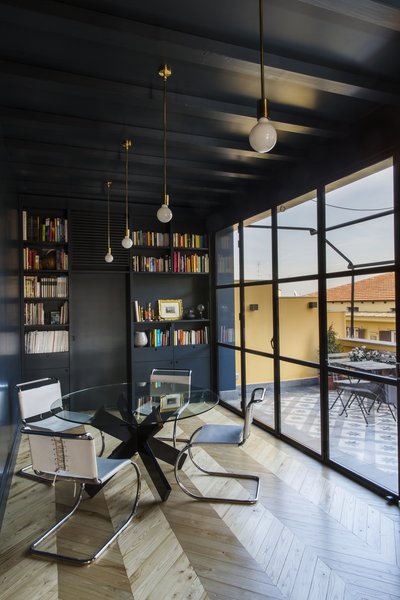 At the corner between the dining room and the kitchen is a small outdoor terrace with floor-to-ceiling glass doors that bring plenty of sunlight into the home.

