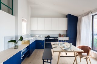 Oak dining table by Woud, and oak chairs by Gareth Neal for The New Craftsmen.