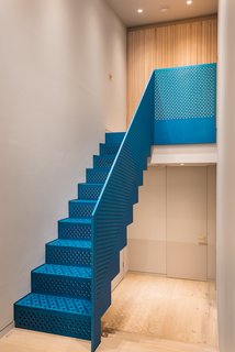 The eye-catching metallic blue staircase was produced by Joe Faller Fabrications.