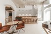 Modern home with Dining Room, Wall Lighting, Terrazzo Floor, Table, Chair, and Pendant Lighting. “All spaces, both internal and external, were restored and designed to accommodate all the new features of the hotel with harmony and comfort,” says Marina. Photo 6 of La Dimora Di Matello