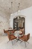 Modern home with Living Room, Chair, Pendant Lighting, Terrazzo Floor, and Table. Manca Studio hired skilled workers with experience in historical restoration to recover the cave dwellings and repurposes the chambers into comfortable and elegant public areas and four intimate and romantic suites. Photo 7 of La Dimora Di Matello
