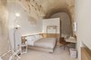 Modern home with Bedroom, Bed, Night Stands, Floor Lighting, Terrazzo Floor, and Chair. Minimal furnishing conveys an aesthetic that is neutral and linear Photo 13 of La Dimora Di Matello