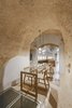 Modern home with Dining Room, Pendant Lighting, Chair, Terrazzo Floor, and Table. This minimalism highlights the curves and textures of the cave walls and ceilings. Photo 14 of La Dimora Di Matello