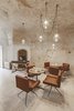 Modern home with Dining Room, Table, Pendant Lighting, Chair, and Terrazzo Floor. Light oak wood furniture, Corten-steel details, and neutral toned textiles bring modernity and warmth into the cloistered interiors. Photo 9 of La Dimora Di Matello