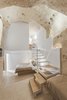 Modern home with Bedroom, Bed, Wall Lighting, and Terrazzo Floor. All four guestrooms look like natural grottos with ceilings as high as 15-feet. Photo 10 of La Dimora Di Matello
