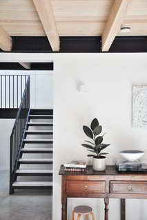 Strategically placed light wells, screens, and openings allow light to move across the surfaces of the house throughout the day. 