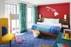 Modern home with Bedroom, Bed, Carpet Floor, Floor Lighting, Wall Lighting, Chair, and Night Stands. A warm and cheerful "Aloha Photo 16 of Shoreline Hotel Waikiki