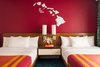 Modern home with Bedroom, Wall Lighting, Night Stands, Bed, and Carpet Floor. The sign above the bed is replicated from Dan Mazzarini's own handwriting. Photo 15 of Shoreline Hotel Waikiki