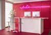Modern home with Hallway. In the concierge section of the open-air lobby is a neon pink wall with “Aloha” neon signage. Photo 5 of Shoreline Hotel Waikiki