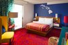 Modern home with Bedroom, Table Lighting, Carpet Floor, Bed, Chair, Night Stands, Wall Lighting, Lamps, and Floor Lighting. Custom-designed carpets, drapes, furniture, bedding, and a “you are here Photo 13 of Shoreline Hotel Waikiki